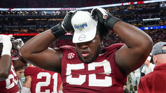 Dec 2, 2023; Atlanta, GA, USA; Alabama Crimson Tide offensive lineman Tyler Booker (52) wears an SEC Championship hat at Mercedes-Benz Stadium. Alabama defeated Georgia 27-24 to claim the SEC Championship.